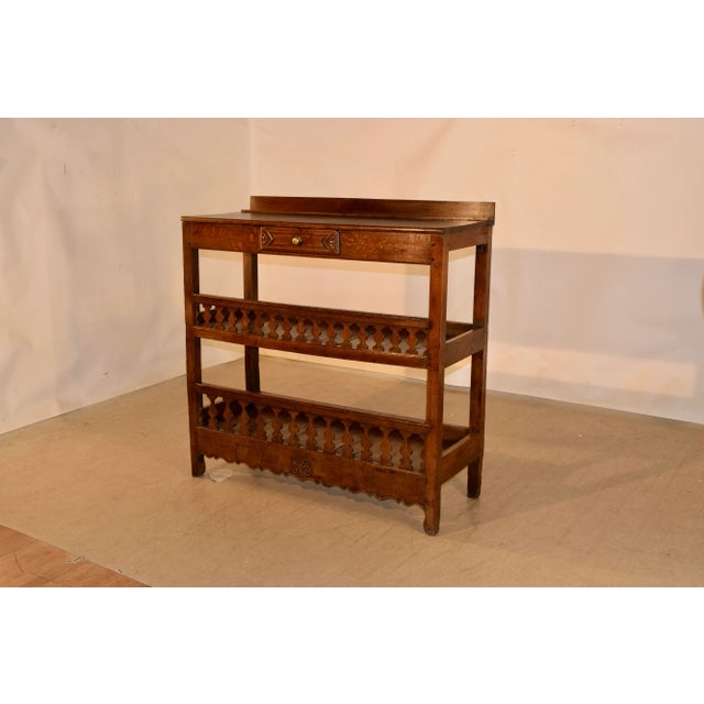 19th century oak baker's rack from France. This is a lovely form with a small backsplash following down to a simple apron...