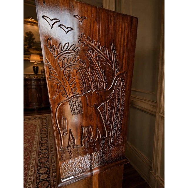 An exceptional and monumental hand-carved African display cabinet and sideboard, originally imported from Malawi and...