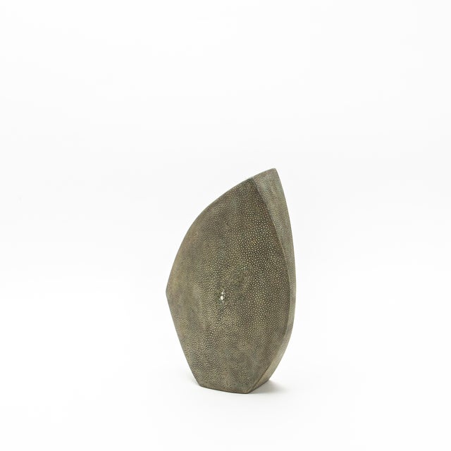 This exquisitely hand-crafted vase by R&Y Augousti, known as the "Oval Vase with the Side Cut Top," is a sublime marriage...