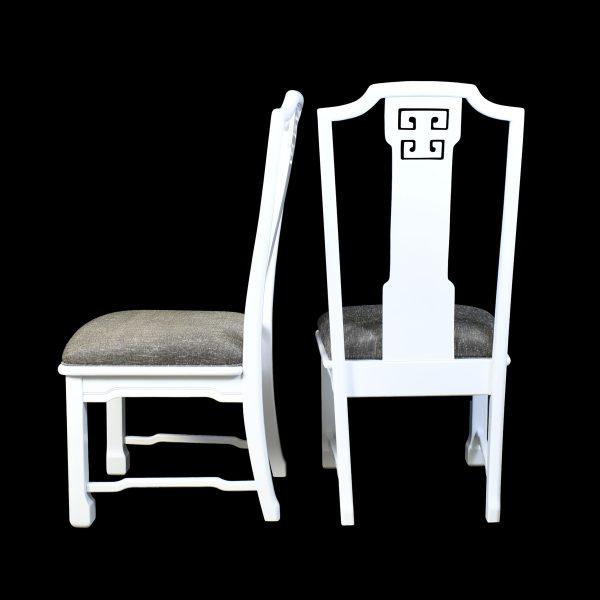 A set of six Ming-style dining chairs in crisp white lacquer with newly done upholstery, ready to seat a full table in...
