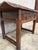 18th century Spanish trestle-leg table featuring a beautifully timeworn plank top and richly carved apron with original...