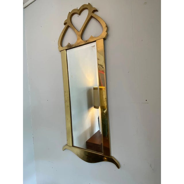Vintage brass hanging mirror for Mastercraft has some patina but is in overall good condition. Width shown below is the...