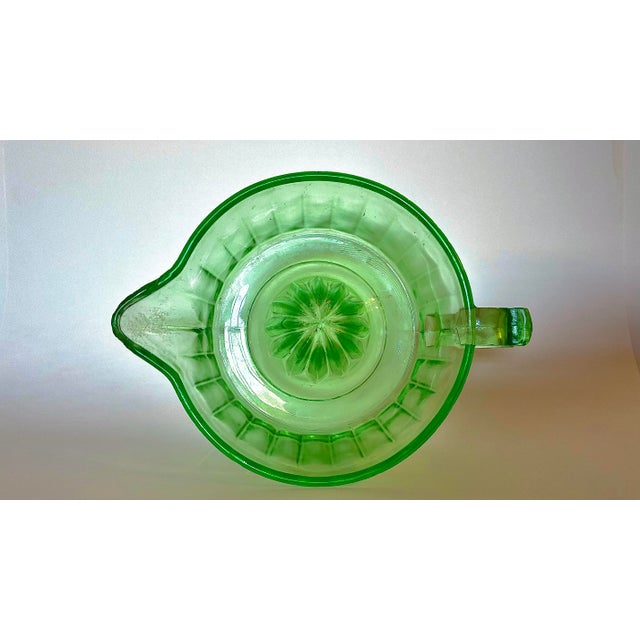This piece is a Beautiful vintage uranium green glass juice reamer, produced by the Indiana Glass Company during the...