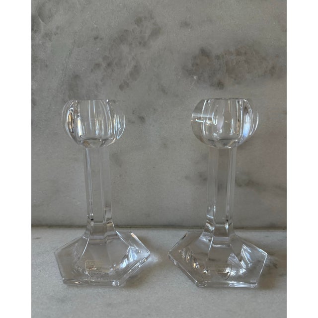 Pair of vintage Orrefors Sweden candlesticks in clear cut crystal featuring a polygon base, faceted column stem and...