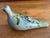 Vintage Mexican Tonala pottery dove with hand-painted floral folk motifs in blue, green, and yellow on a pale grey ground....