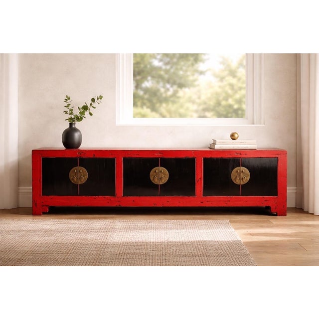 Antique Chinese low cabinet or Kang table with a distressed red lacquered frame, six black cabinet doors, moon-shaped...