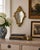 An Italian Rococo–style giltwood wall mirror, richly carved with scrolling acanthus and shell motifs that give the piece...