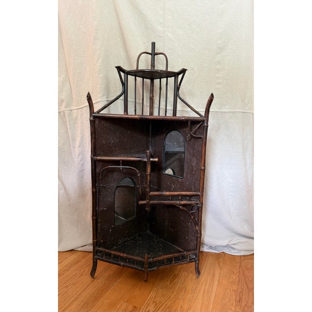 Beautiful and unique, this antique English Aesthetic Movement corner shelf or etarge can be set on top of another piece or...