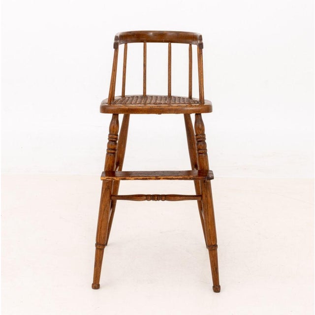 Victorian Cane-Paneled Oak Spindle Back Children's High Chair. 29.75" H x 15.5" W x 18" D; seat: 23" H. Provenance: From a...