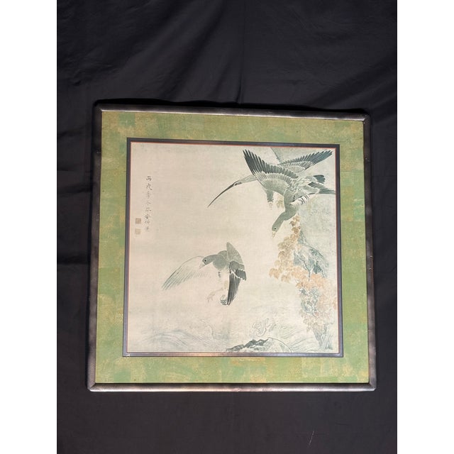 Elegant framed painting on paper in a traditional East Asian ink and wash style. The artwork depicts birds in flight over...