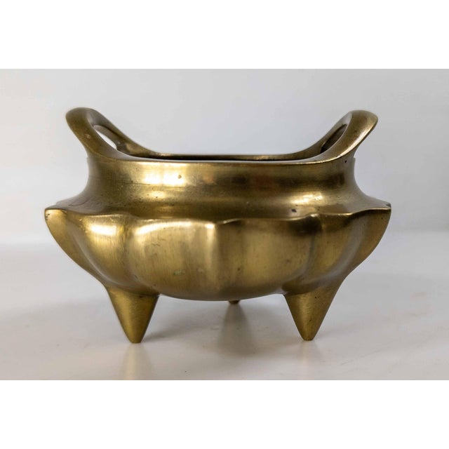 We are selling this nice Chinese bronze tripod censer. This censer has nice finished form with lobed sides and low rise...