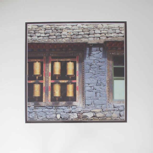 A large, matted photo titled 'Prayer Wheels at Sakya Monastery' depicts a prayer wheel 'once at the center of the Sakyapa...