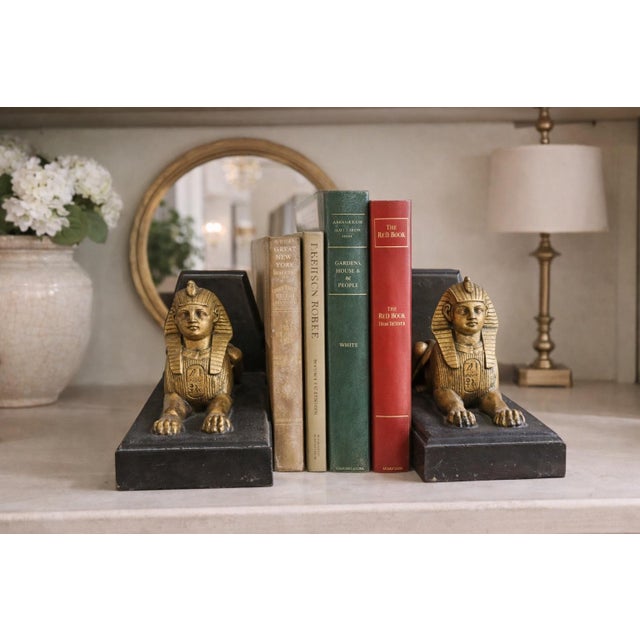 Add an iconic touch of glamour and ancient-inspired design to your library or décor with this striking pair of Egyptian...