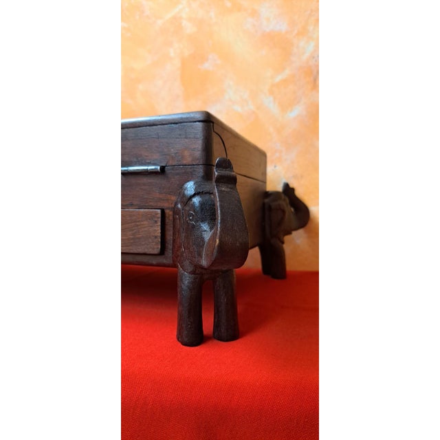 Antique solid wood secretary box. It features four elephant supports with raised trunks, believed to bring good luck. The...