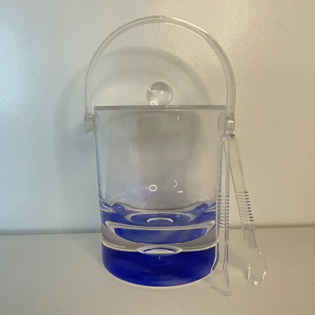 Vintage Home is pleased to offer this Vintage Lucite Ice Bucket with Tongs. The design has a Royal Blue base that is...