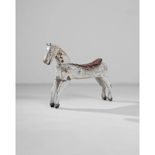 This antique wooden horse was crafted in France, circa 1900. Beautifully distressed, this svelte colt exhibits a joyous...