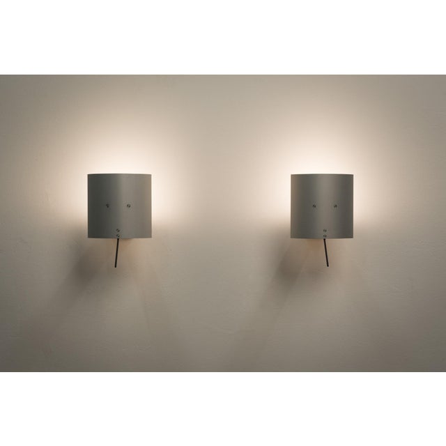 The lamps are adjustable in a variety of ways to suit different lighting situations. This piece has an attribution mark, I...