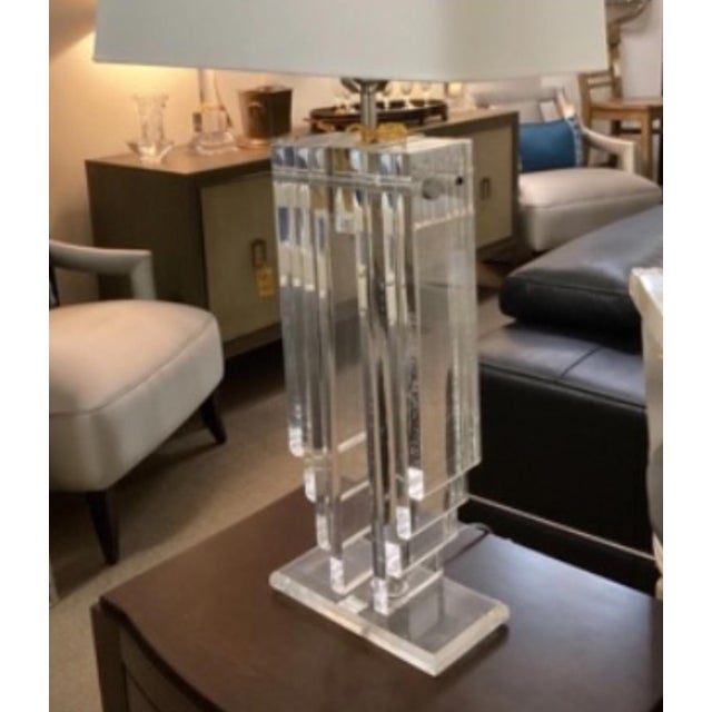 Pair of stacked Lucite table lamps with brass hardware. Dimensions: Height: 26 in (66.04 cm)Width: 10 in (25.4 cm)Depth: 5...