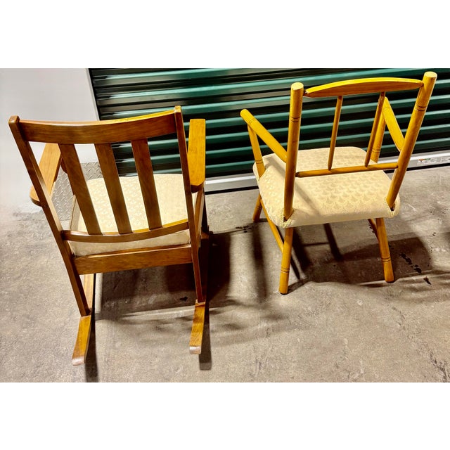 The primary chair is an Arts & Crafts style rocking chair, characterized by its sturdy wooden oak and embodies the design...