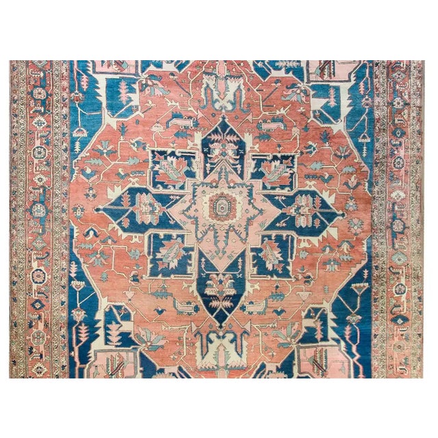 The most beautiful late 19th century Persian Serapi rug with a bold stylized floral medallion woven in crimson, light and...