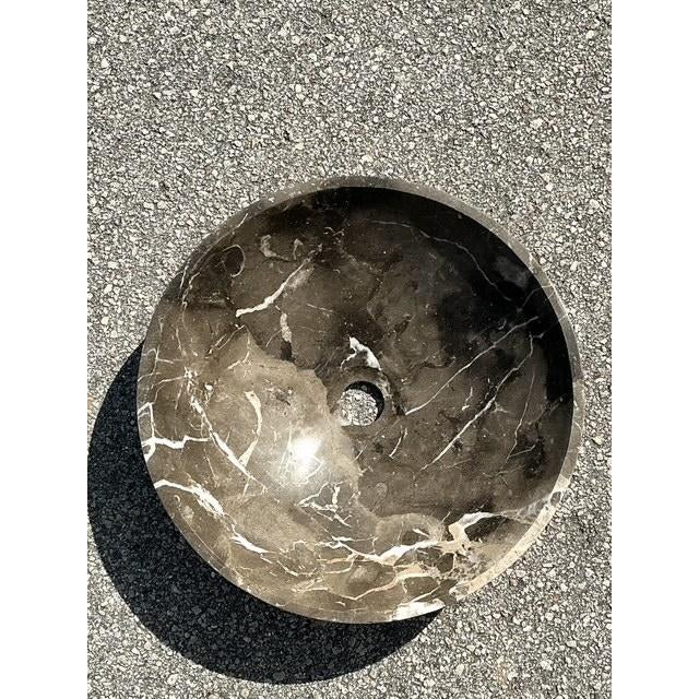 This striking vintage vessel sink is a masterclass in minimalist design and organic luxury. Expertly hand-carved from a...