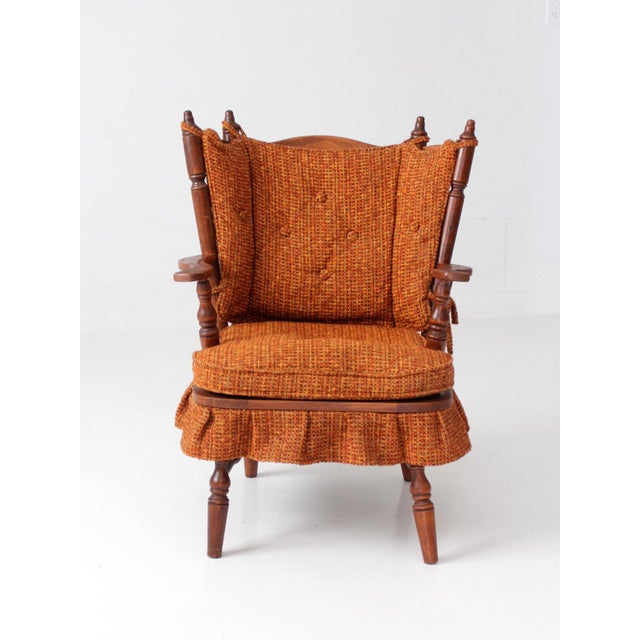 A mid-century spring rocking chair in the Colonial Revival tradition, with a beautifully articulated wood frame and strong...