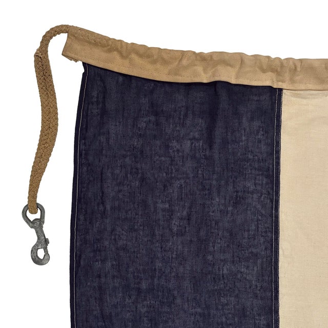 This vintage signal flag is fully sewn from a sheer cotton cloth in navy blue and off-white. Please note overall staining...