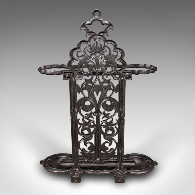 This is an antique ornate stick stand. An English, cast iron umbrella loop, dating to the Victorian period, circa 1880. A...