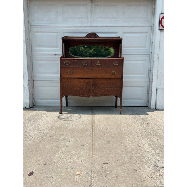 We have a beautiful Antique Arts & Crafts dressing cabinet for sale! It features stunning quarter sawn oak, an original...