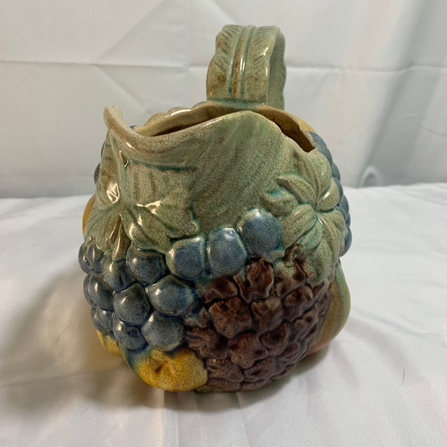Add a splash of kitschy retro charm to your kitchen setup with this vibrant, hand-painted ceramic pitcher. Inspired by...