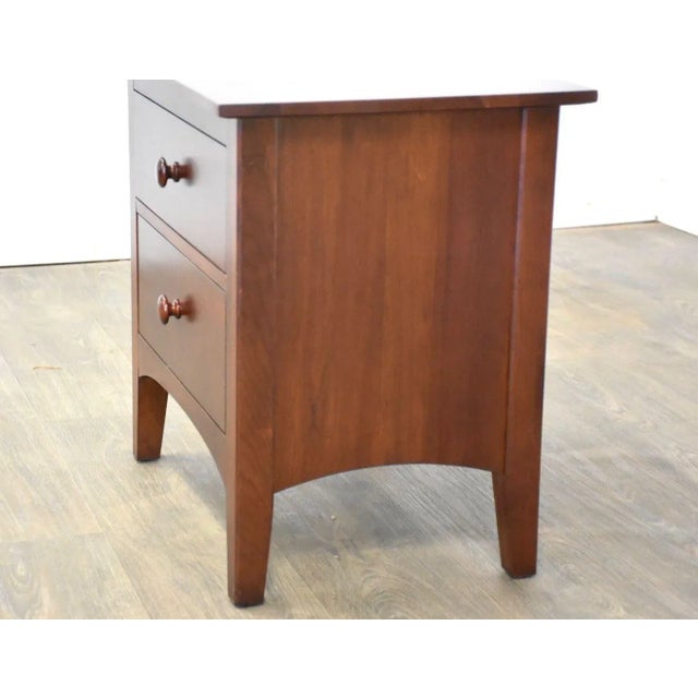 A solid cherry two drawer nightstand made by Ethan Allen American Impressions. 24.75” wide. 17” deep. 23.25” tall.