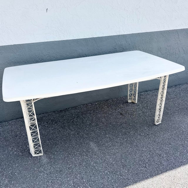 A distinctive Mid-Century Modern rectangular dining table showcasing the era’s fascination with sculptural form and...