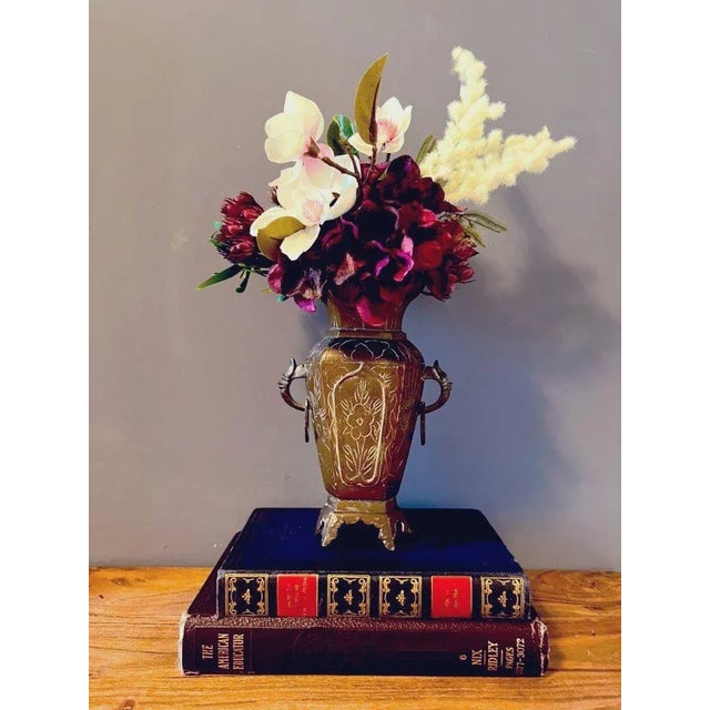 Beautiful heavy, antique ornate brass vase/ urn with detailed handles and floral etched designs. Marked at the bottom:...