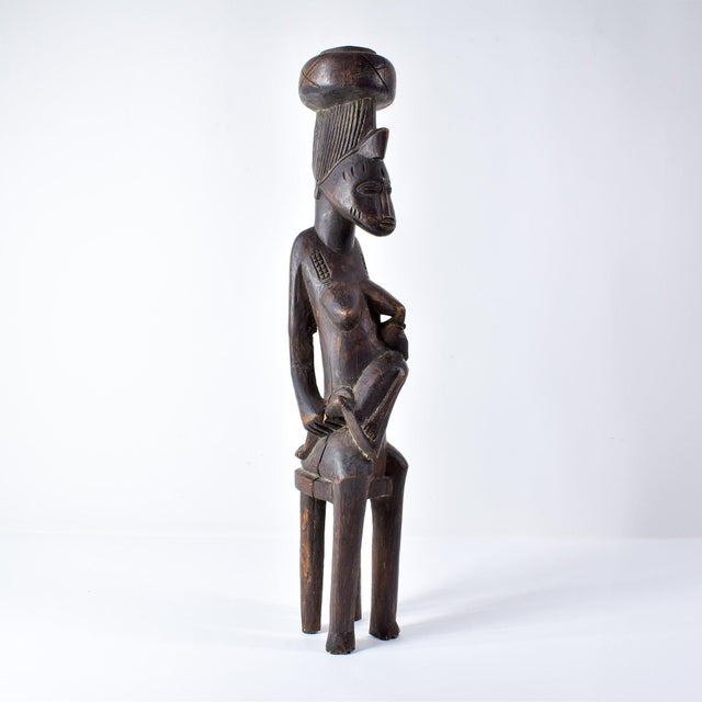 This expressive female figure with a child is from the Senufo people of the Ivory Coast (CÃ´te d'Ivoire), Mali, and...