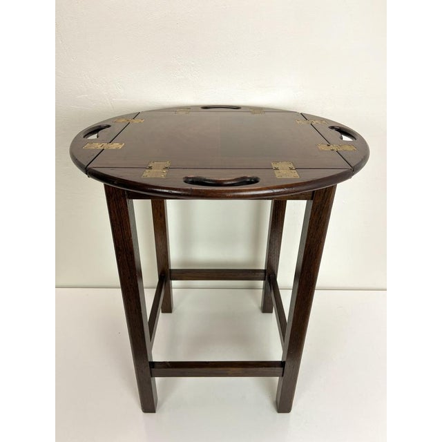 A smart and functional butlers tray side table in wood. This is Georgian style it and dates from around the 1970's. It is...