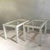 Pair of rectangular coffee tables circa 1970. The angular metal frame is coated in cream with top edge in brass framing...