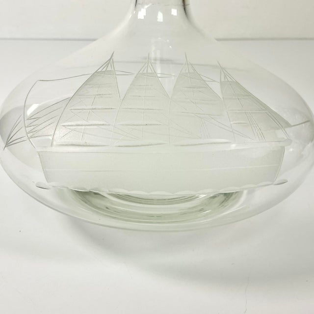 This is a large crystal Decanter from the 1970s. It features an etched 4-Mast Tall Skipper Ship. The stopper is a large...