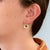 Vivid Zambian emeralds are set against brushed matte 14K yellow gold in these distinctive stud earrings, finished with...