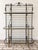 An elegant vintage French-style baker’s rack featuring a wrought iron frame accented with brass and 9 glass shelves....