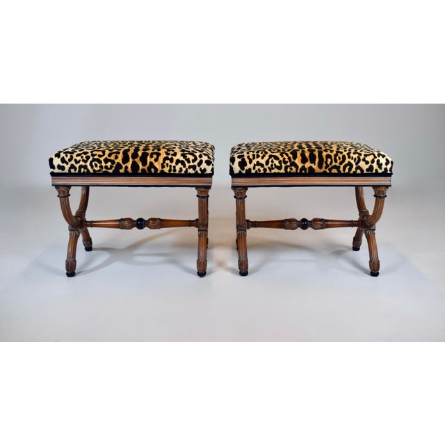 A superb pair of Neoclassical style curule ottomans /benches /stools, featuring sinuous X-form cross-curule bases,...