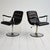 Set of two 1970s swivel armchairs with a steel frame and black vinyl upholstery with a contrasting back. A pair of swivel...