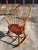 Beautifully made Windsor style rocking chair in what looks like maple, having modeled seat and fine spindles on a curved...