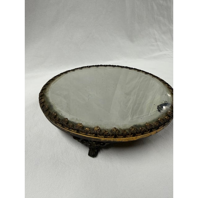 Elegant detail to this beveled mirror Plateau. Lion footed creates a stately feature. This piece is antique and does have...