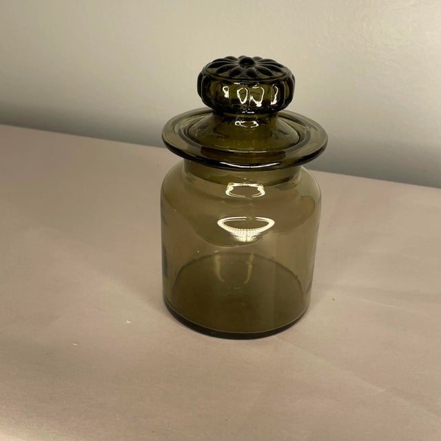 Vintage smoked glass jar with lid. Circa the mid 20th century. Made in USA. The jar is in great shape with no damages to...