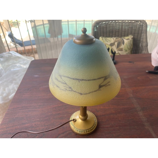 Here is a really fun reverse painted shade with original gold leaf base. While there is a chip on the bottom of the lamp,...
