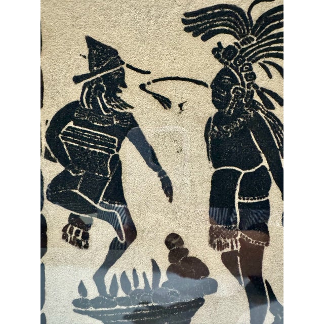 Framed Mexican folk art depicting a Mayan ceremonial scene titled "Prueba al Fuego" (Trial by Fire). Two elaborately...