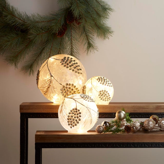 Add a touch of winter magic to your home with these stunning LED Frosted Gold Pinecone Orbs. This set of three glass pine...