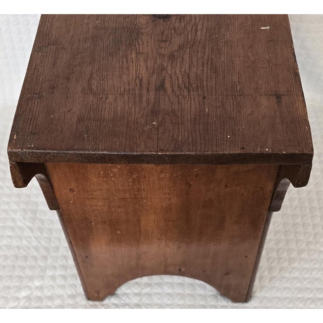 Early American primitive wooden stool or low bench, constructed of solid softwood, most likely pine or fir. The piece...