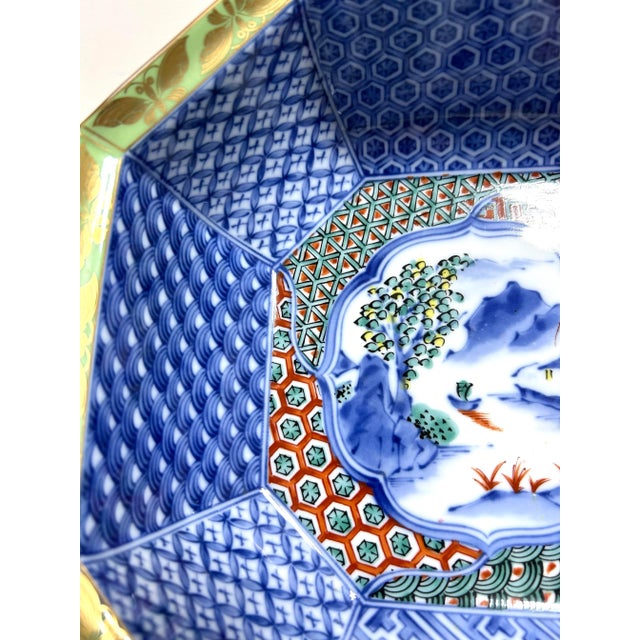 A richly patterned vintage porcelain bowl with an unusual octagonal form, layered cobalt blue decoration, multicolor...