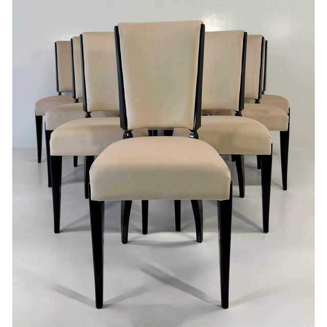 Elegant set of ten French chairs in the late Art Deco style, distinguished by their refined presence and sophisticated...